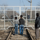 Mar. 1, 2016 – Idomeni, Greece. Refugees look through a border gate into Macedonia (FYROM).